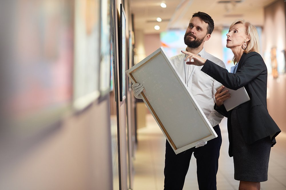 Businesswoman Buying Painting in Art Gallery